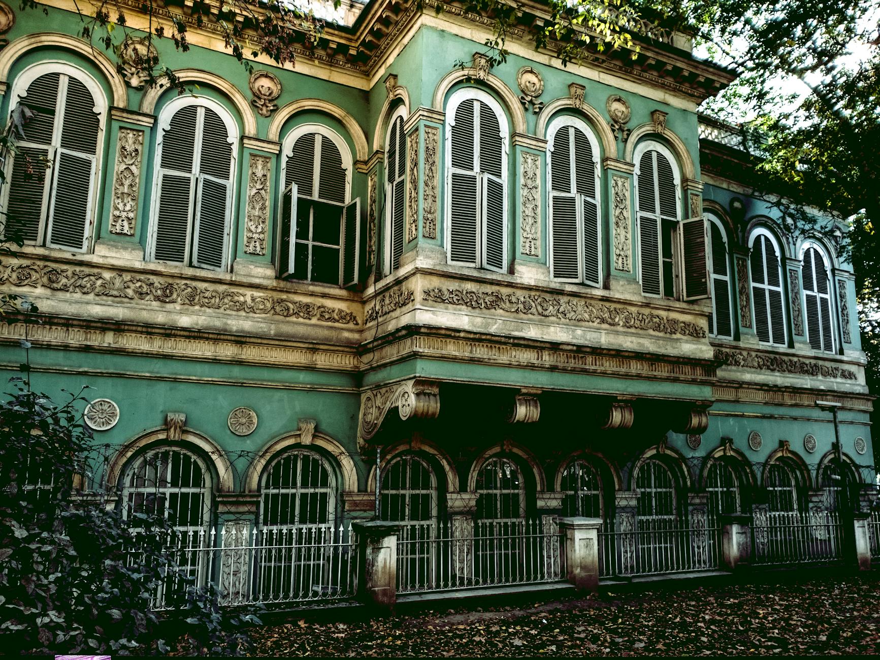 Ornate architectural details adorn a historic green building in Tophane.
