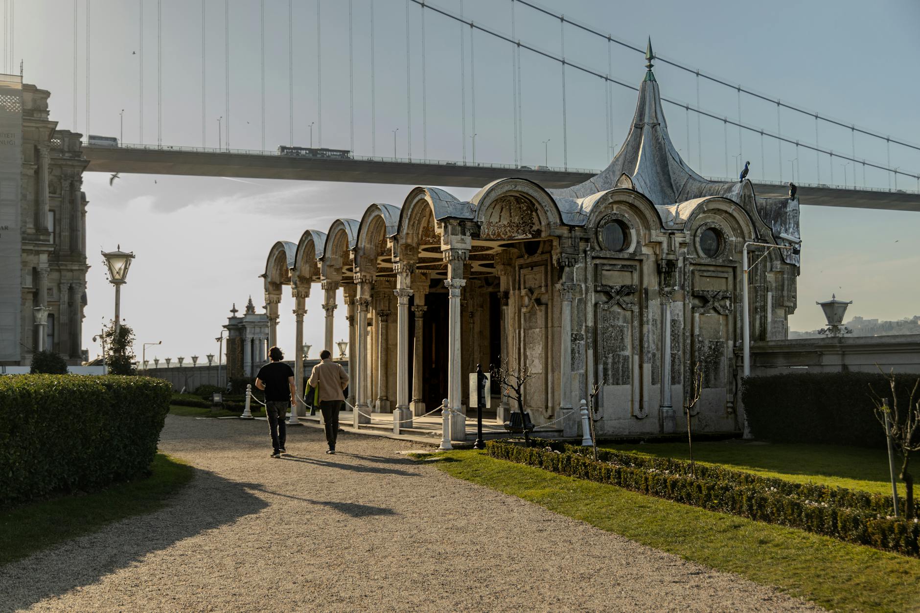 An ornate pavilion at Beylerbeyi Palace stands before the massive Bosphorus Bridge.