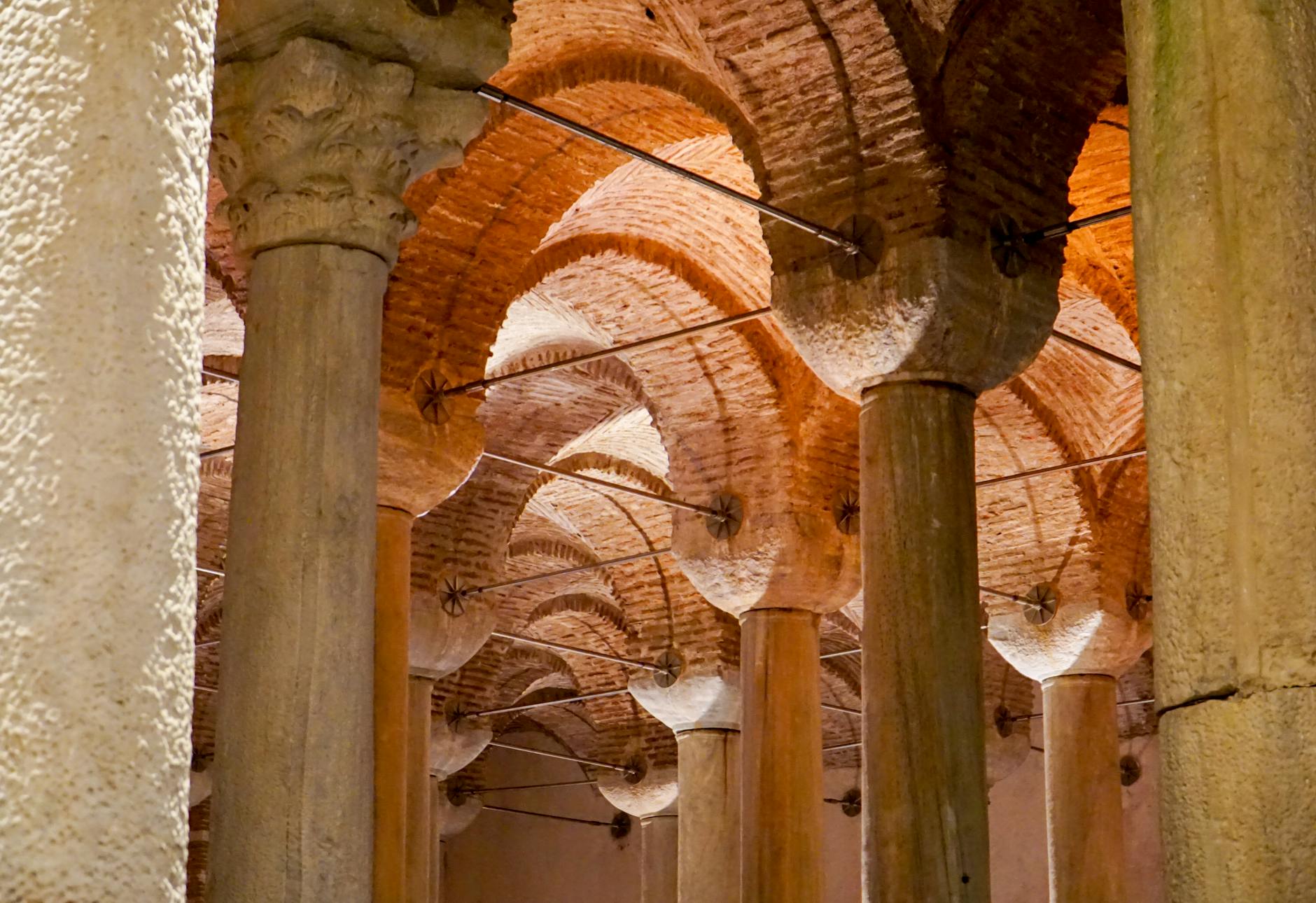 Detailed view of the historic brick arches and stone columns in the Basilica Cistern.