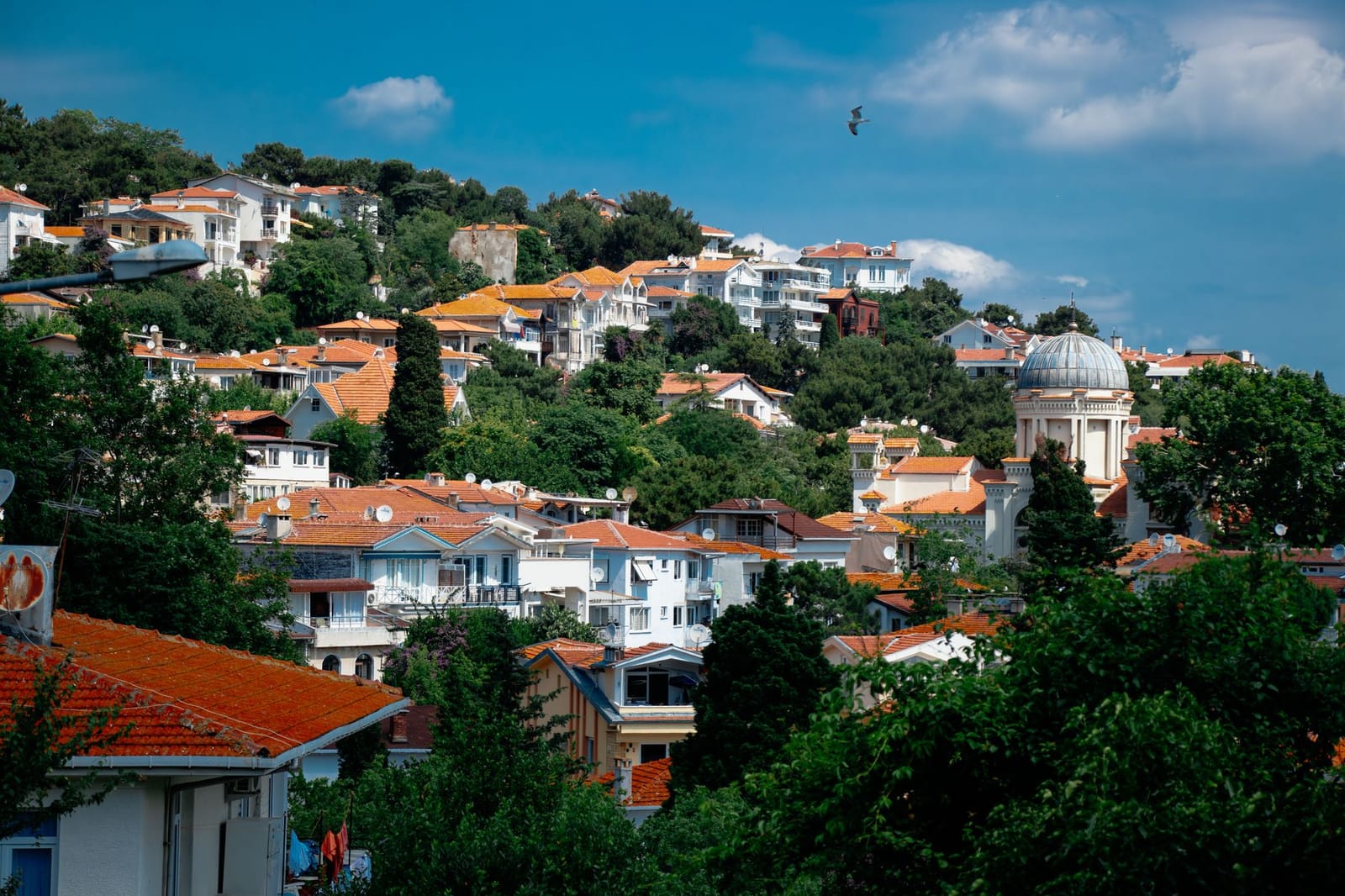 Historic Aya Yani Church dome rising among hillside houses in Burgazada.