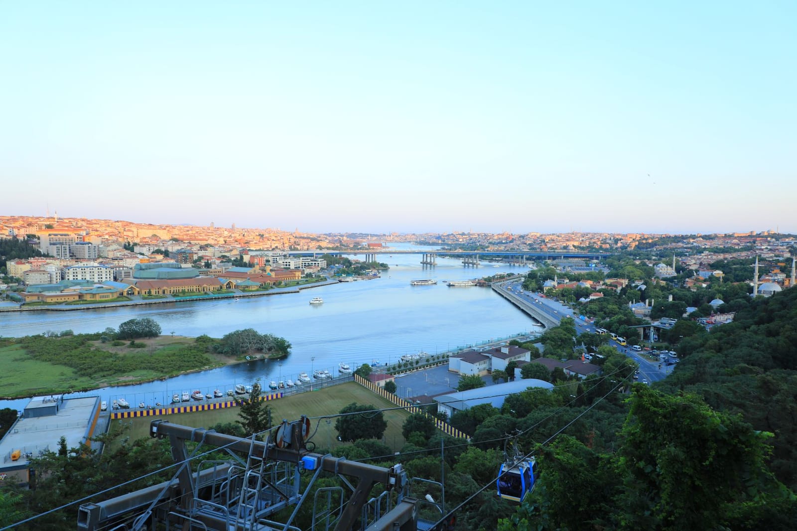 Eyüp cable car cabin descends over trees toward the Golden Horn.