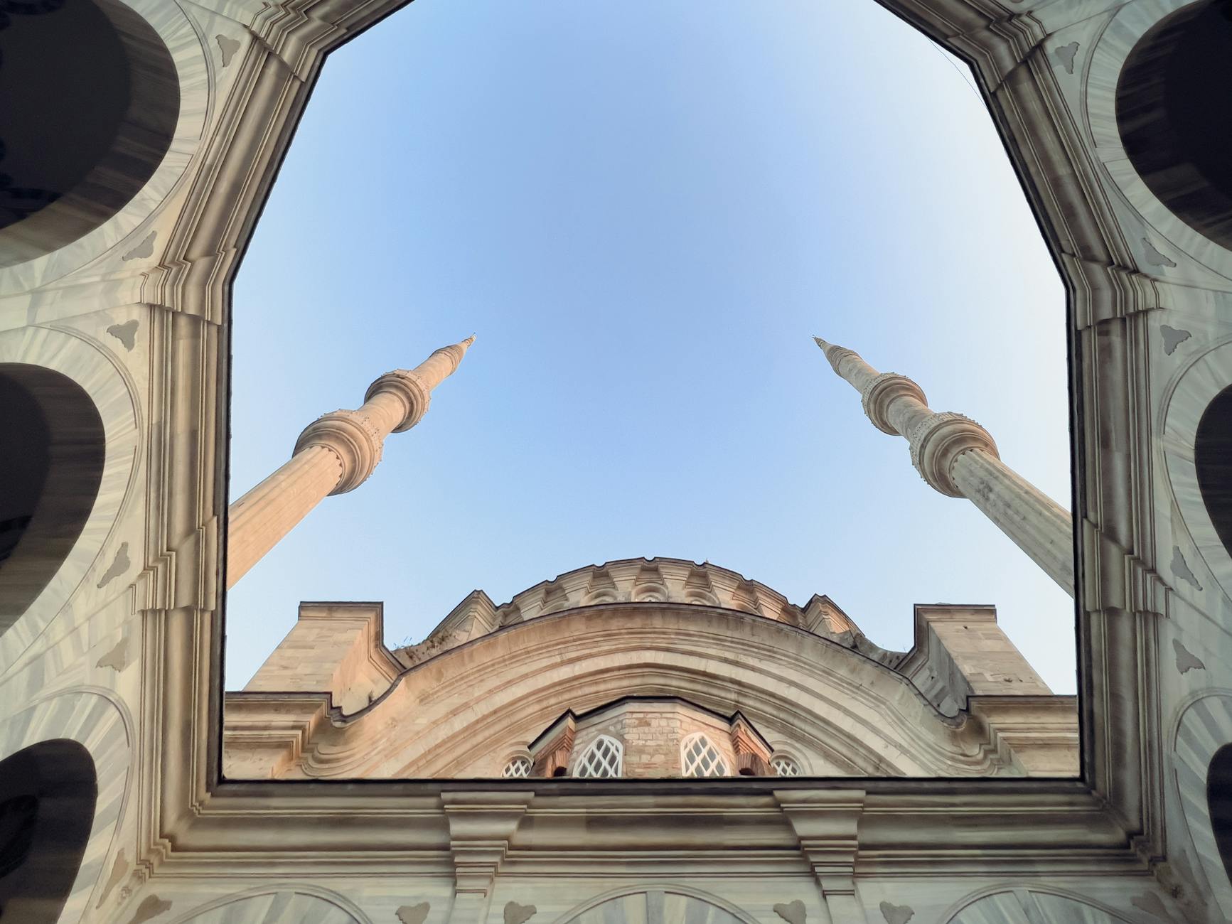 Looking up at the minarets and dome from the mosque inner courtyard.