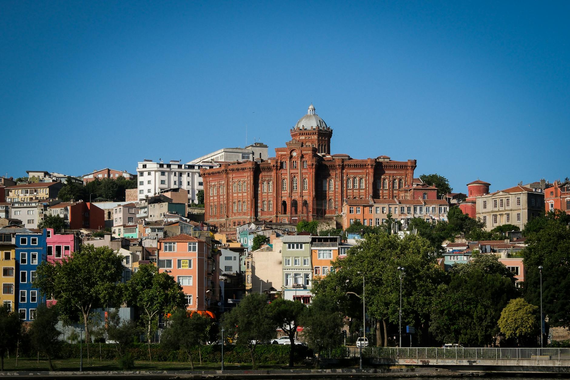 The iconic Red School building overlooking the colorful houses of the Fener district.