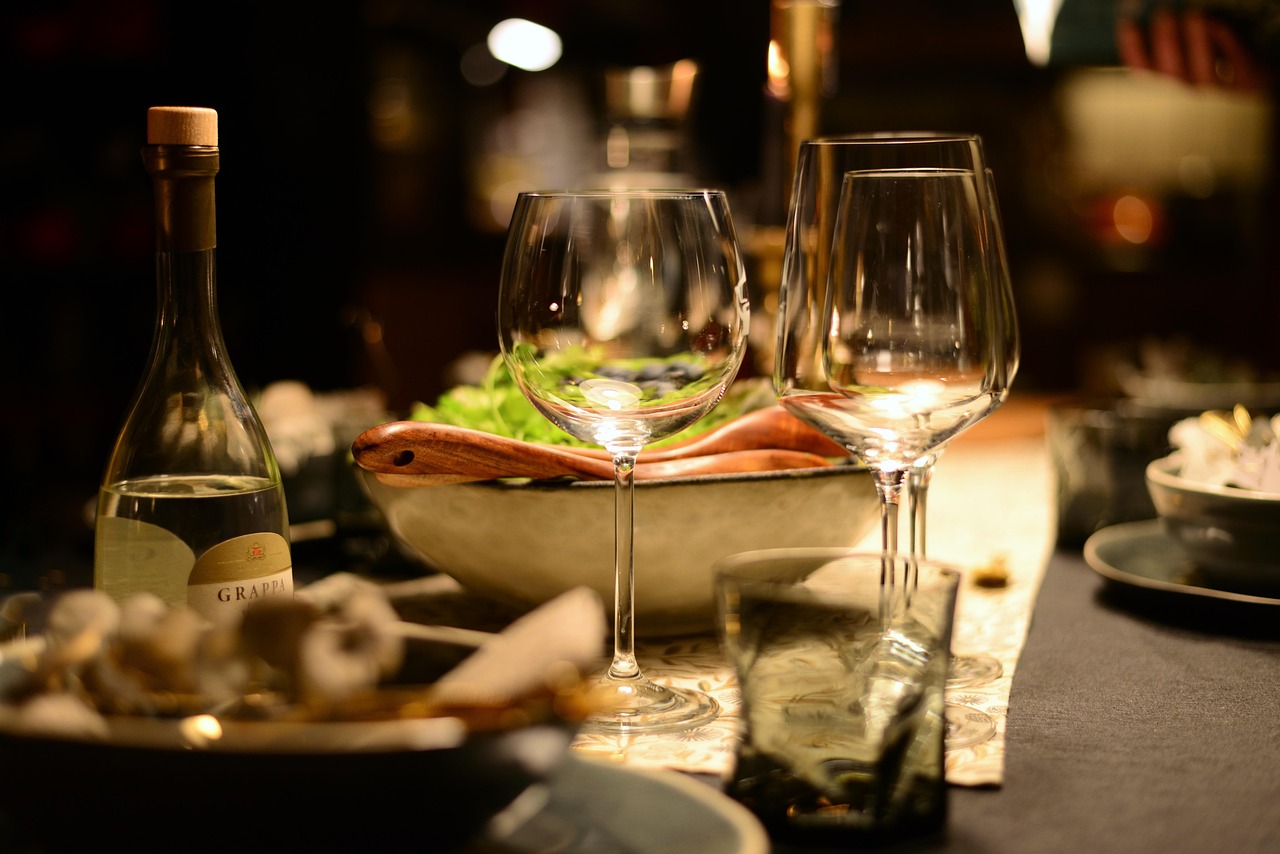 Elegant table setting featuring wine glasses and a bottle of grappa in Istanbul.