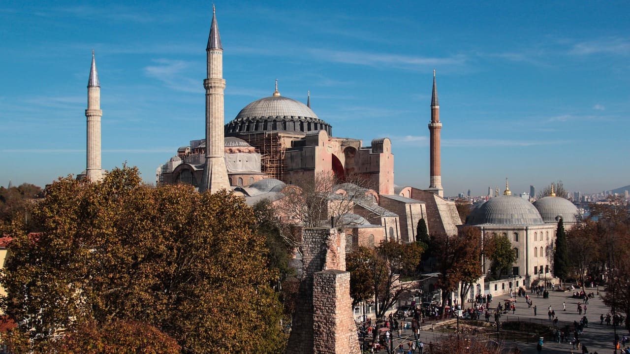 Exterior view of Hagia Sophia in Istanbul with visitors gathered outside the entrance.