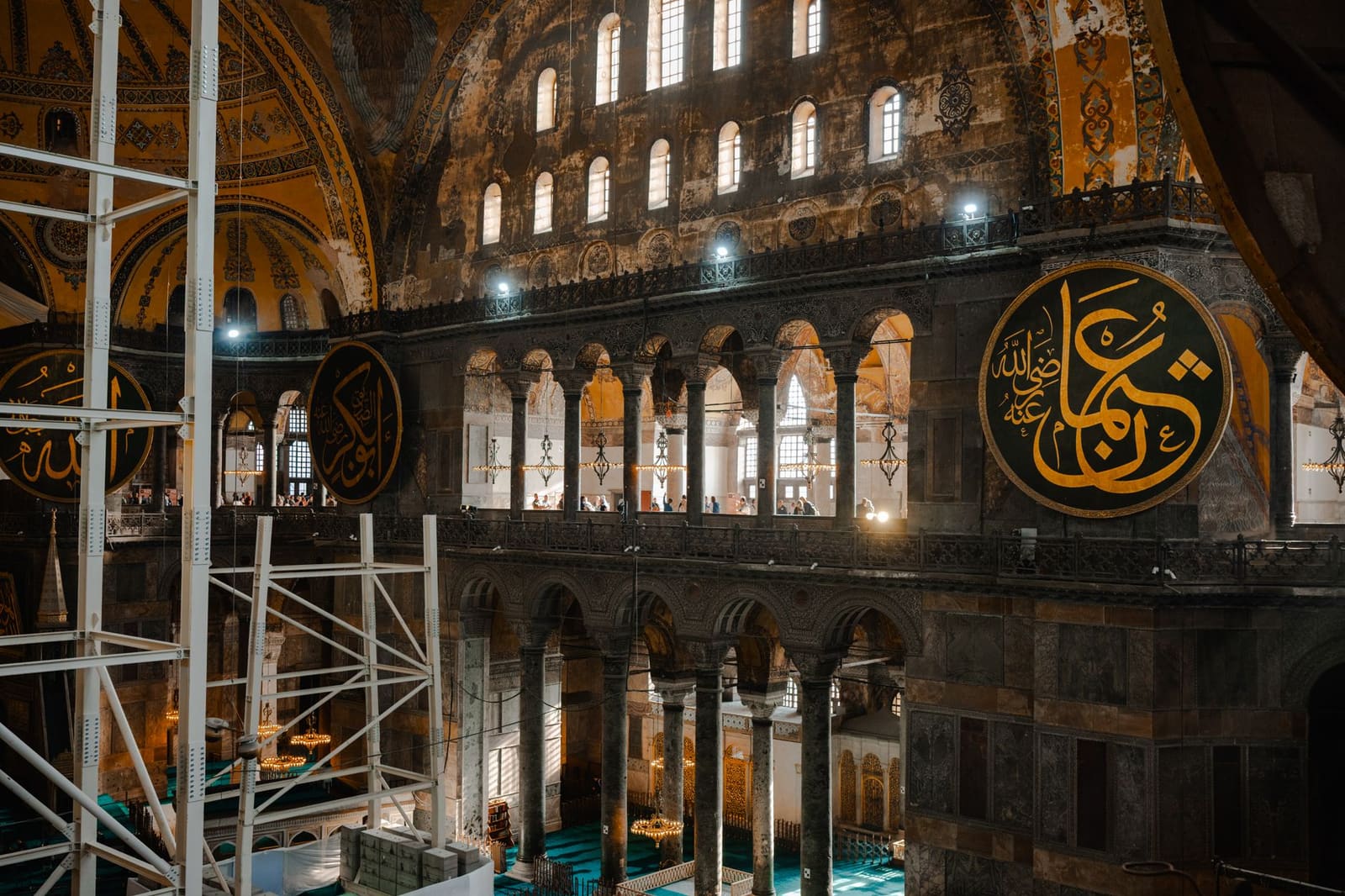 Tourists walk through the elevated upper gallery inside Hagia Sophia.