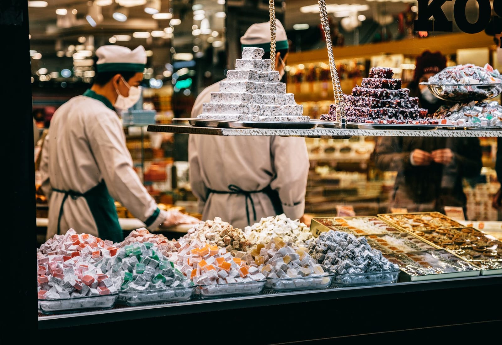 Confectioners serving colourful Turkish delights in a historic Istanbul sweet shop.