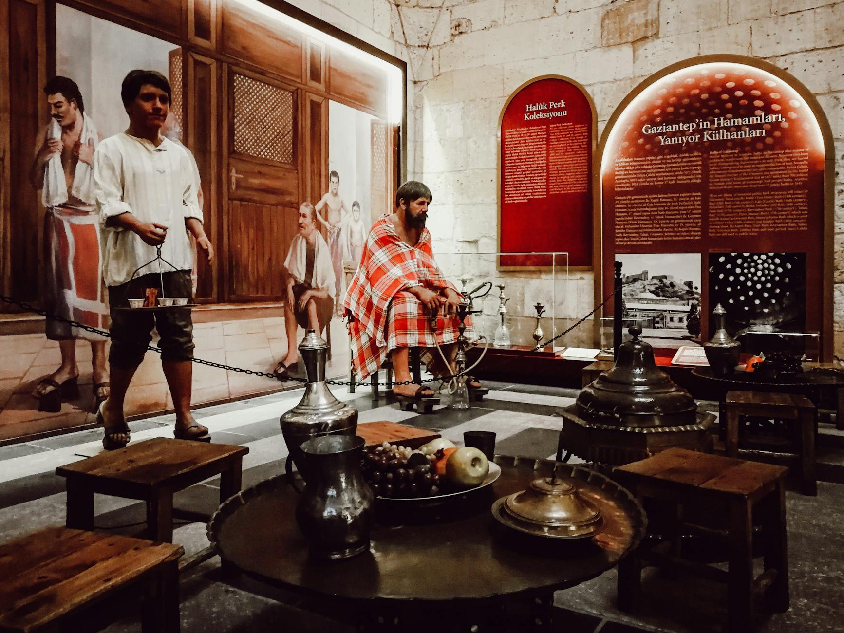 Museum exhibit depicting traditional Turkish bath scenes with mannequins and historical bathing items.