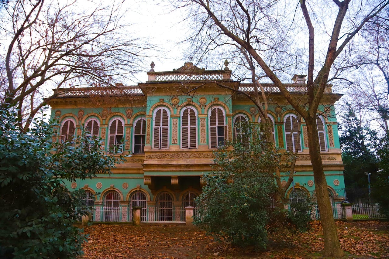 Ornate baroque facade of the historic Ihlamur Pavilion surrounded by lush trees.