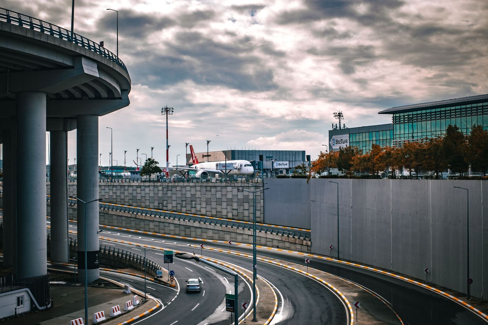 A car navigates multi-level airport roads towards parking facilities in Istanbul.