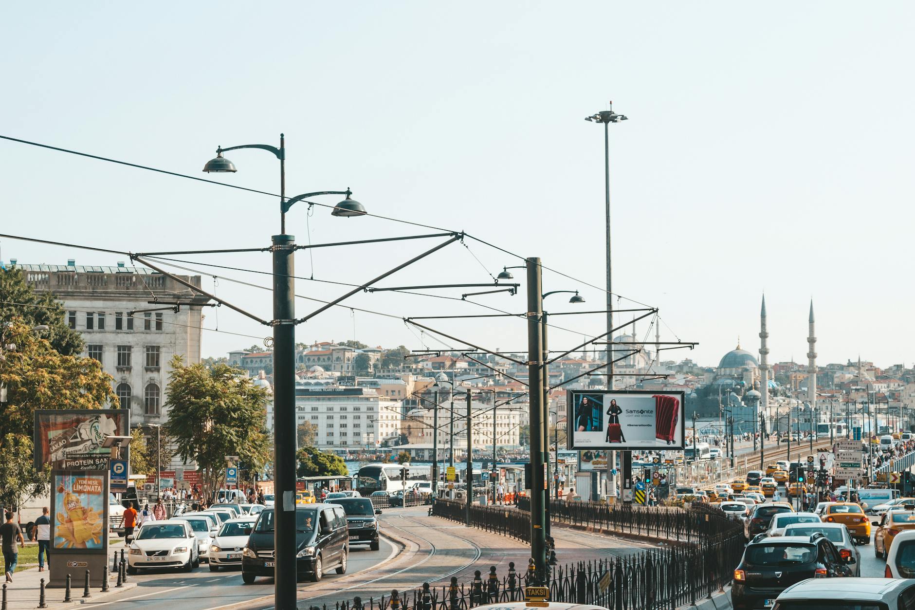 Busy tram tracks and vehicle traffic lead toward the historic mosques in Istanbul's Old City.