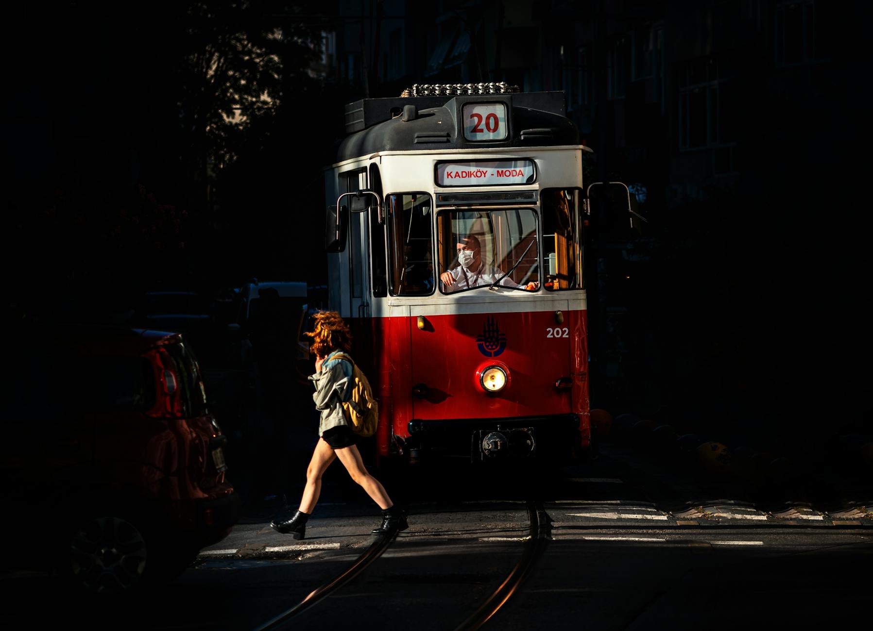 Vintage red tram showing Kadikoy and Moda signage at night in Istanbul.