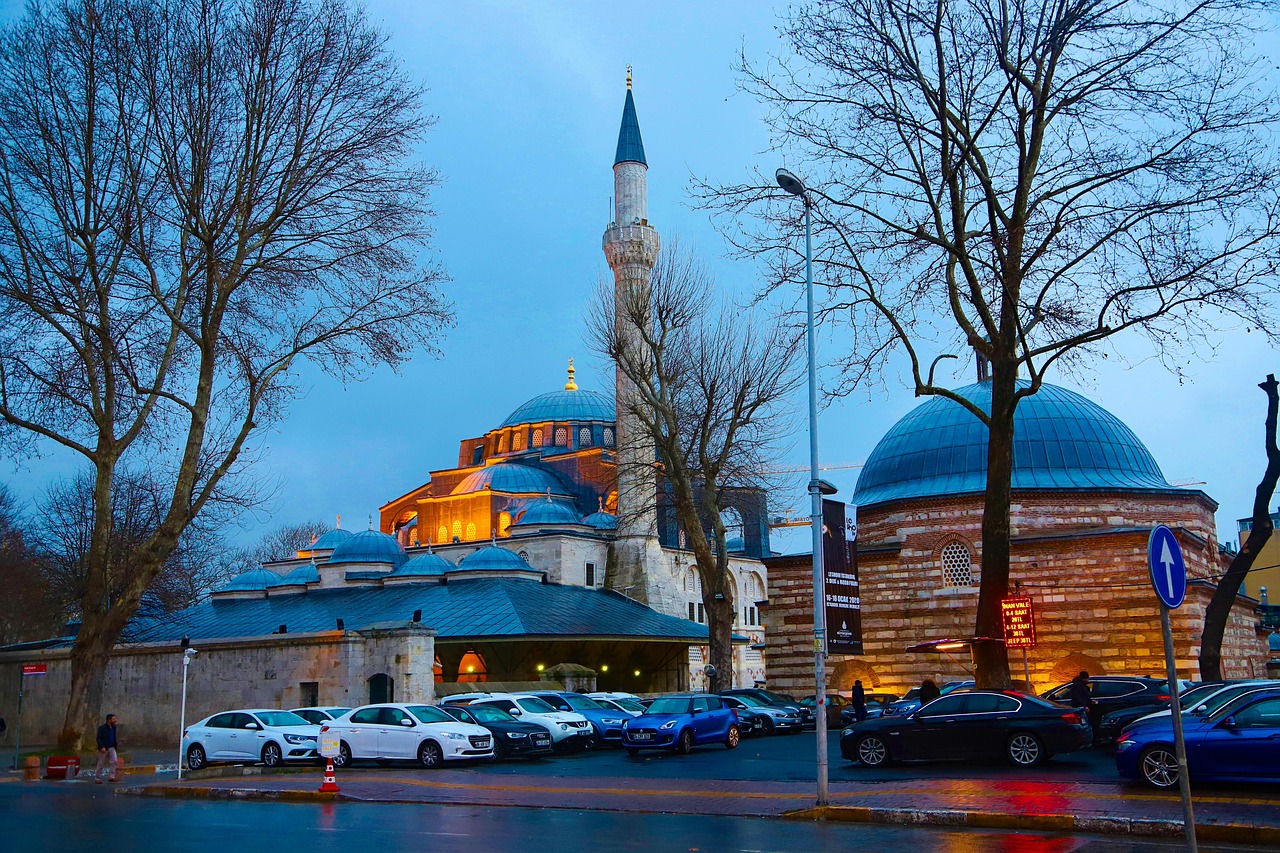 The illuminated Kilic Ali Pasha Mosque stands beautifully at dusk in Istanbul's Tophane district.