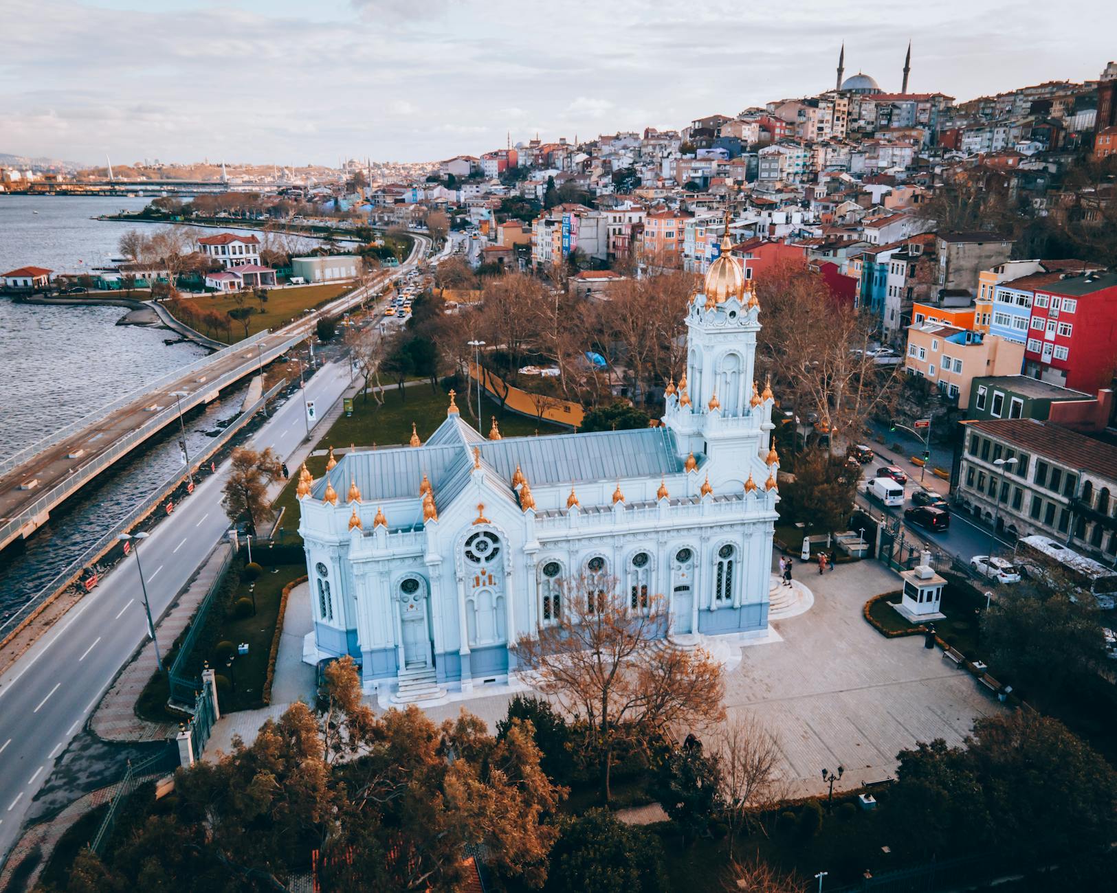 Aerial view of the Bulgarian St. Stephen Church (Sveti Stefan) in Kuzguncuk, Istanbul, with colorful hillside houses nearby.