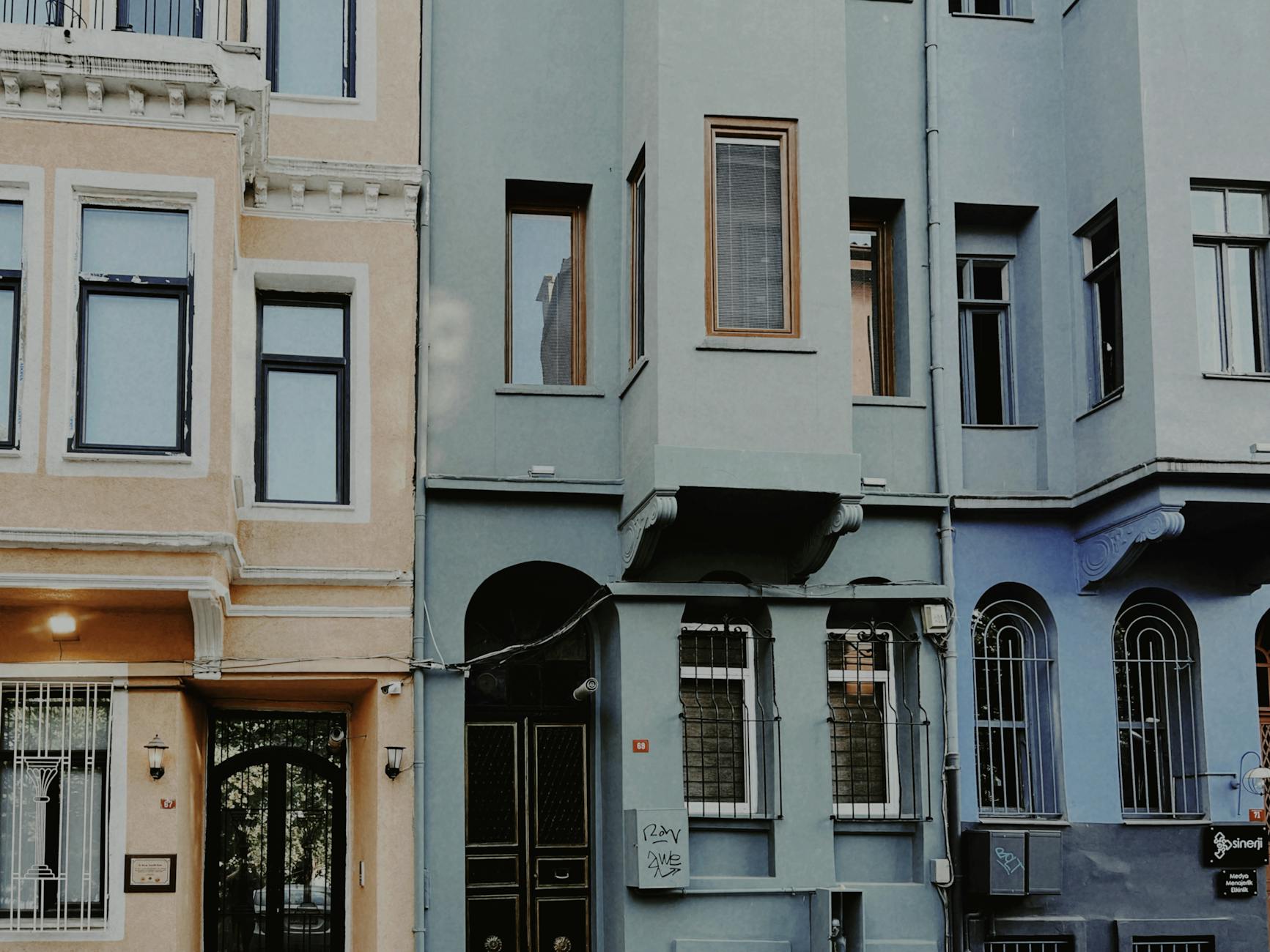 Historic colorful Levantine mansions featuring ornate windows along a street in Istanbul.