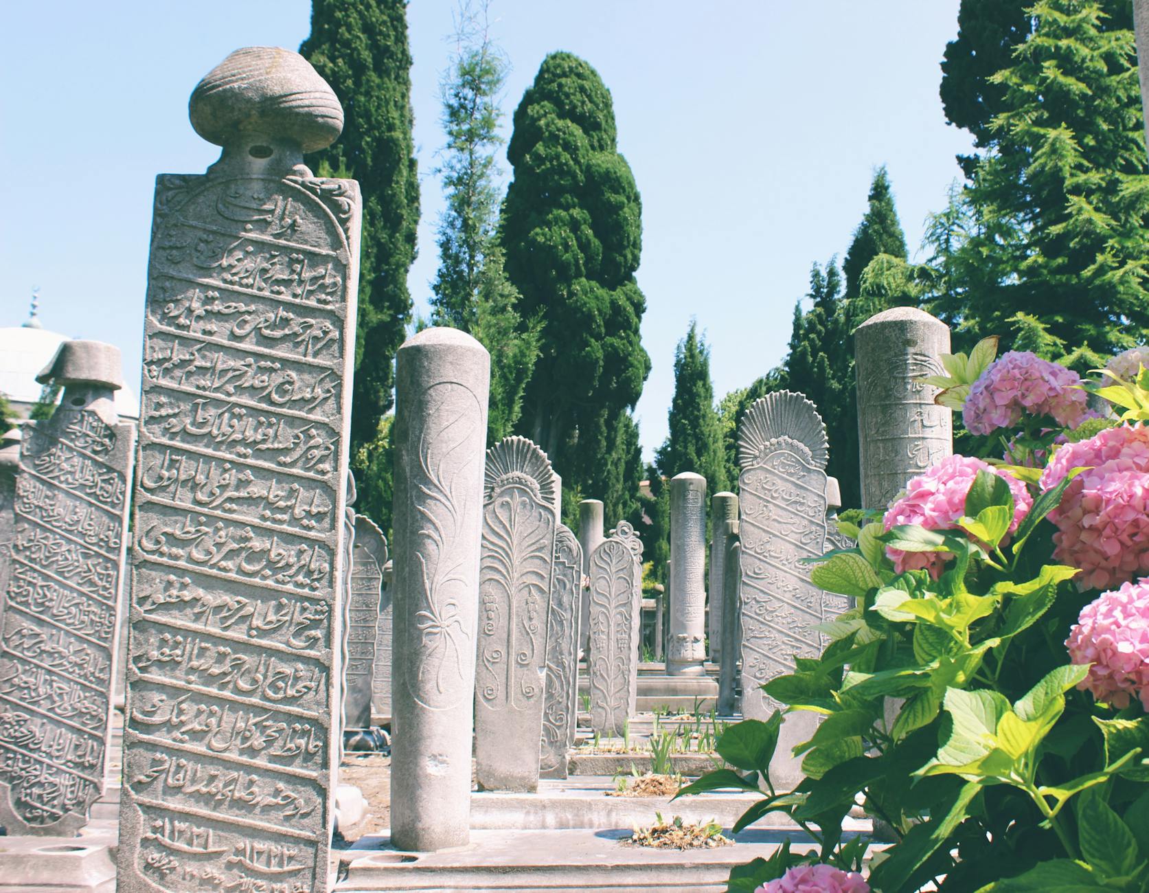 Ottoman era tombstones with intricate calligraphy at the Sultan Mahmud II cemetery in Istanbul.