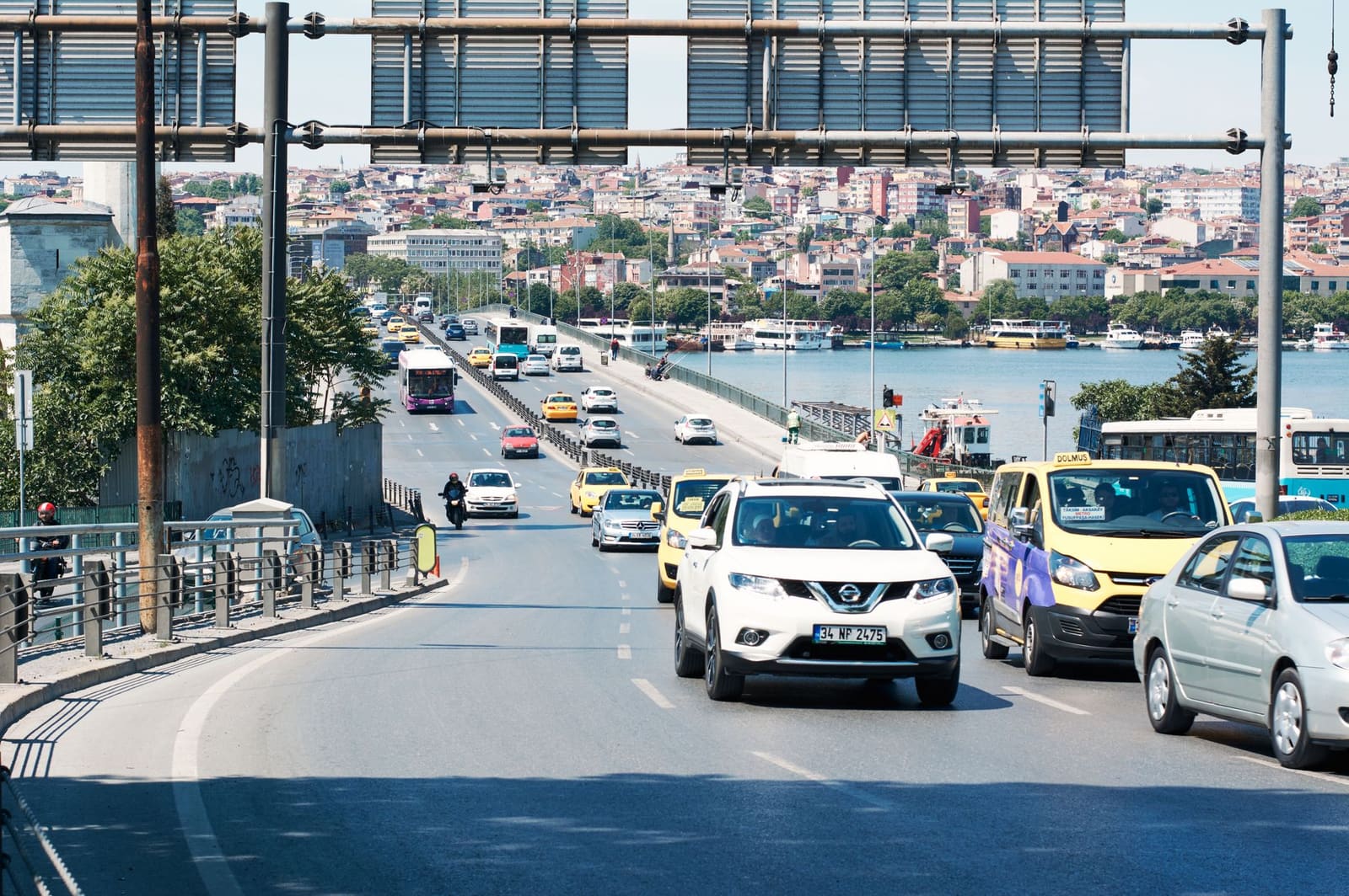 Traffic passes under an overhead electronic road gantry in Istanbul.