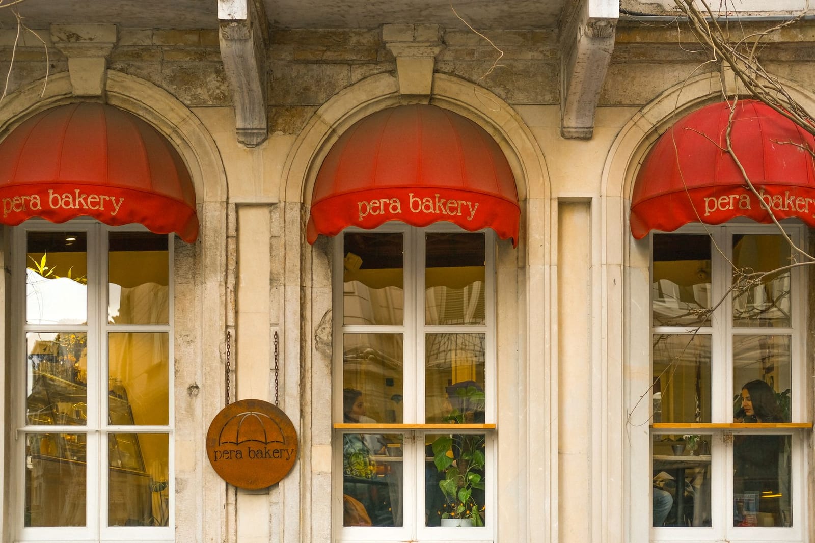 Arched windows and red awnings of historic Pera Bakery in Beyoglu.