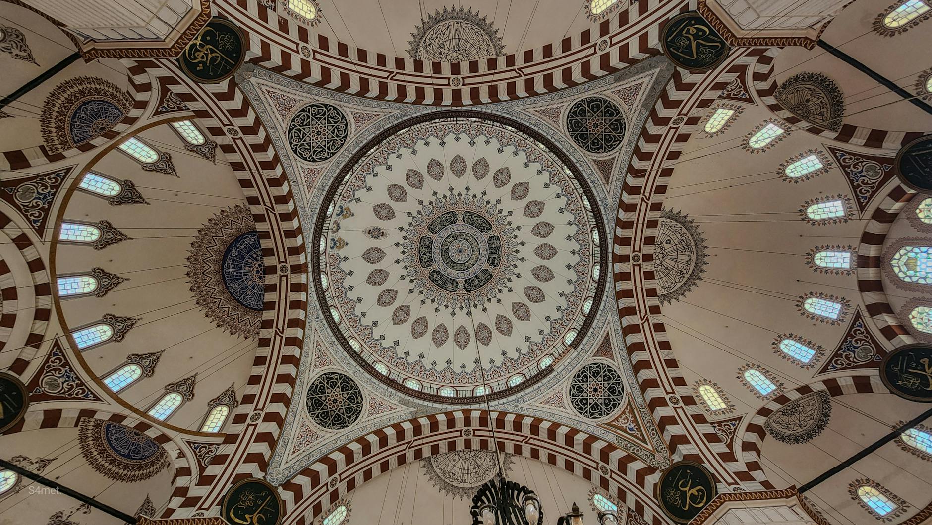 Intricate patterns and calligraphy decorate the interior ceiling of the Şehzade Mosque.