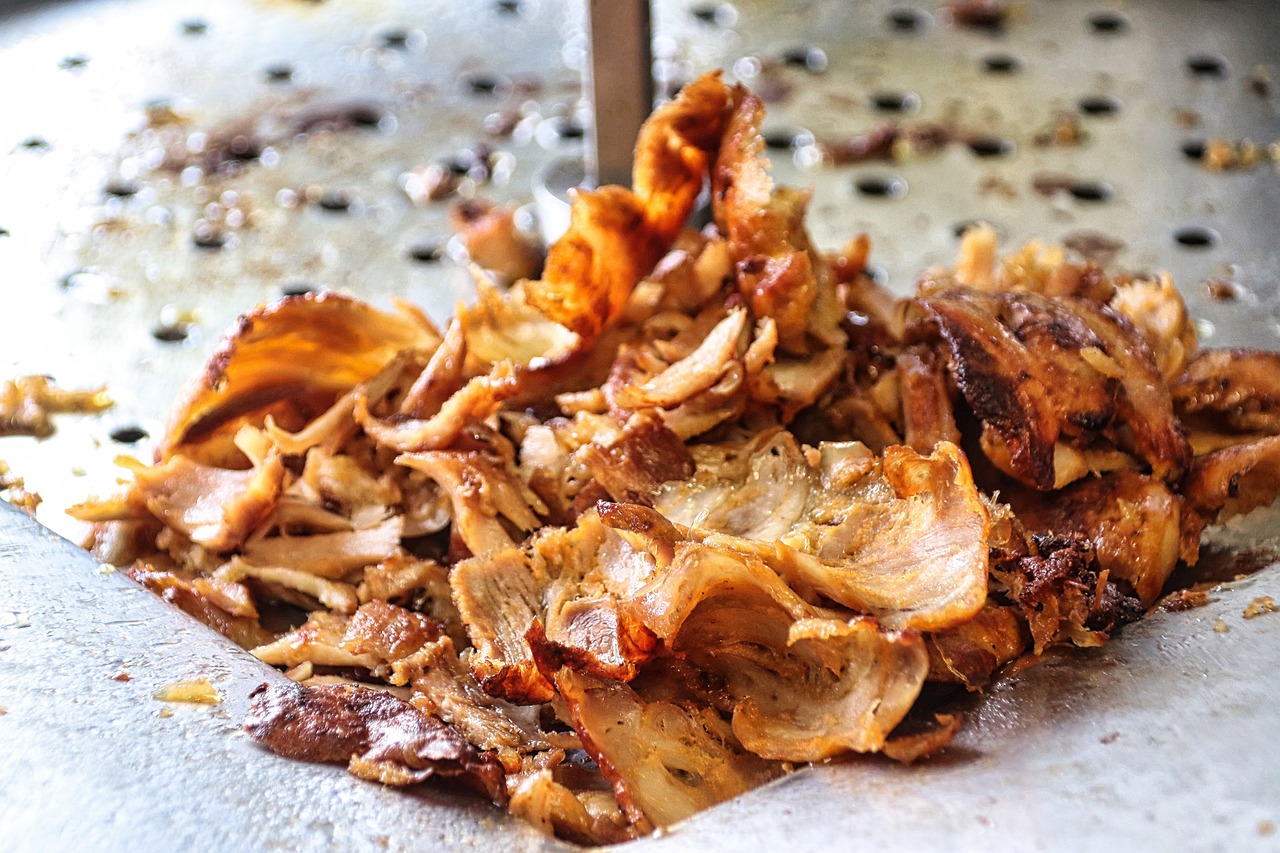 Thin slices of shaved doner meat prepared for an Iskender kebab.