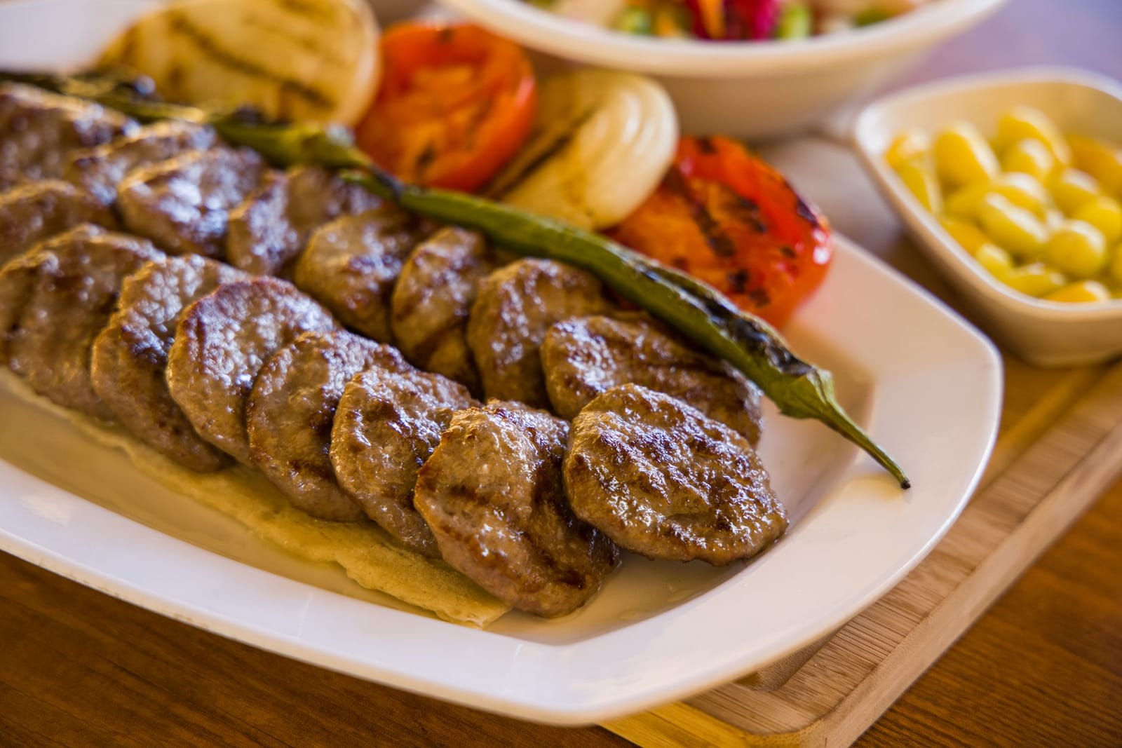 Classic Turkish grilled kofte patties served with roasted pepper and onions.