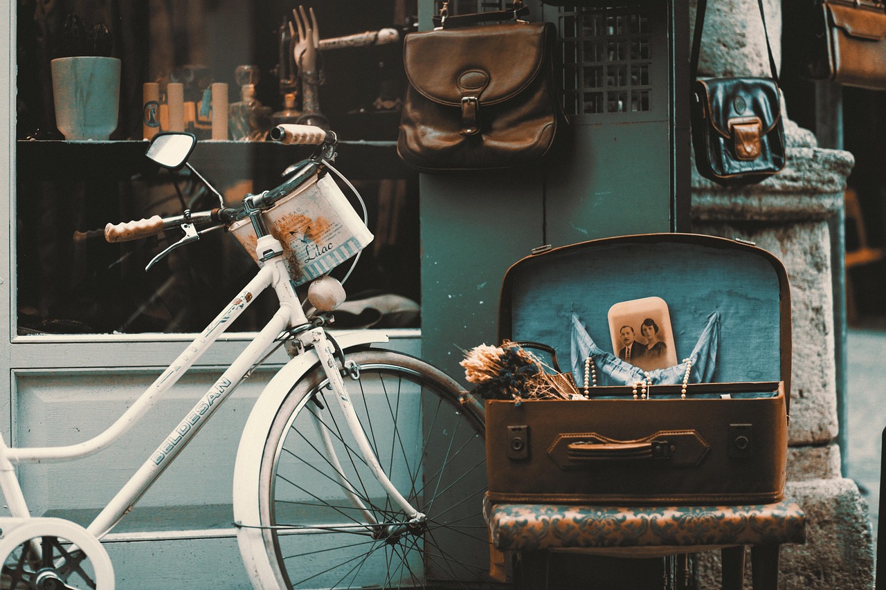 A vintage white city bicycle parked in front of a Turkish boutique shop.