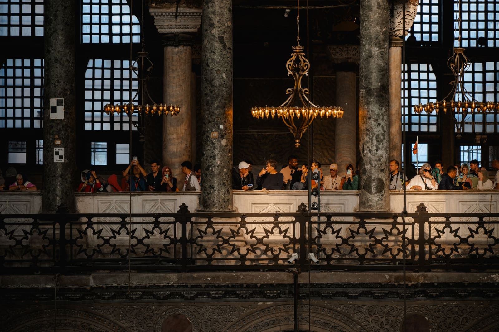 Visitors look down into Hagia Sophia from the upper gallery balcony.