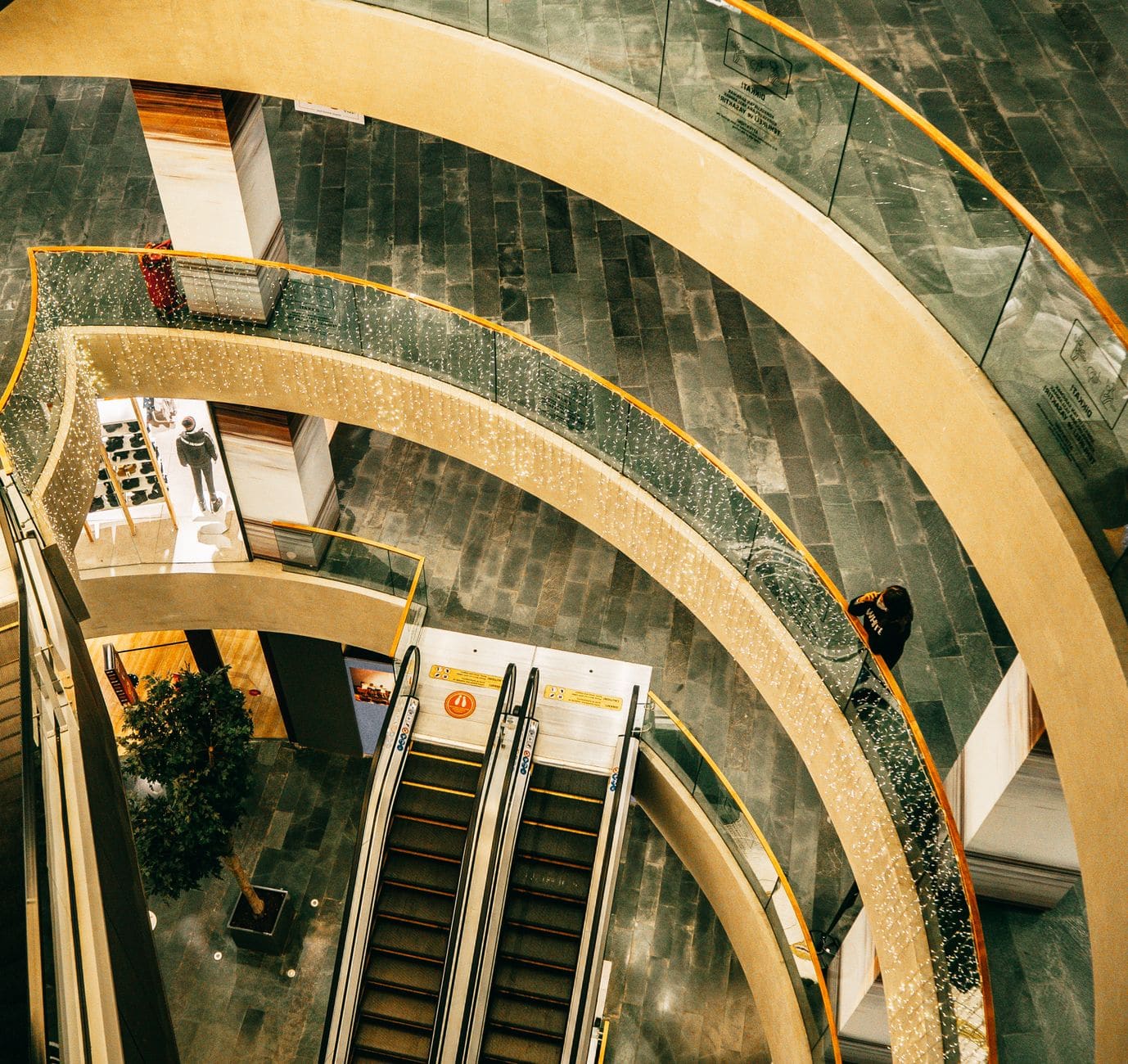 High-angle view of curved balconies and escalators inside Zorlu Center mall.